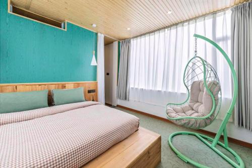 a bedroom with a bed and a swing at U shore house in Quanzhou