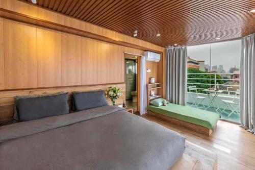 a bedroom with a large bed and a balcony at U shore house in Quanzhou