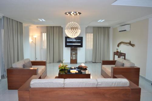 a living room with two couches and a tv at Residence Maryka II in Cotonou