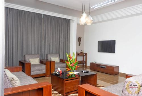 a living room with a couch and a table at Residence Maryka II in Cotonou