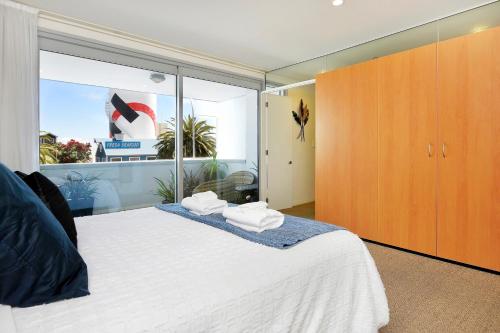 Un dormitorio con una cama con dos toallas encima. en Sea Path Apartment, en Nelson