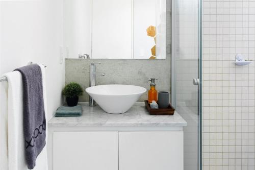 a bathroom with a white sink and a shower at Departamento en Condesa con vista al Castillo de Chapultepec GYM - POOL - PARKING in Mexico City