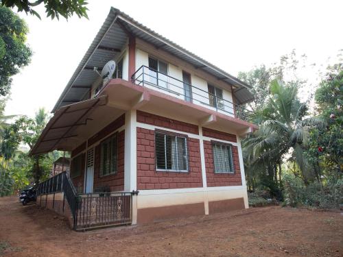 a small house with a balcony on top of it at Bahar Deluxe in Dapoli