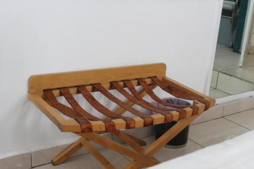 a wooden bench sitting next to a wall at Hotel Villas del Rey in Chachalacas