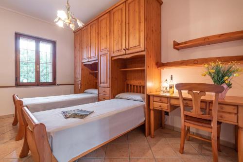 a bedroom with a bed and a desk and a table at Holiday home in Santa Maria La Palma 31431 in Santa Maria la Palma