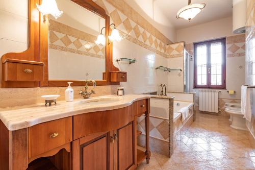 a bathroom with a sink and a tub and a mirror at Holiday home in Santa Maria La Palma 31431 in Santa Maria la Palma