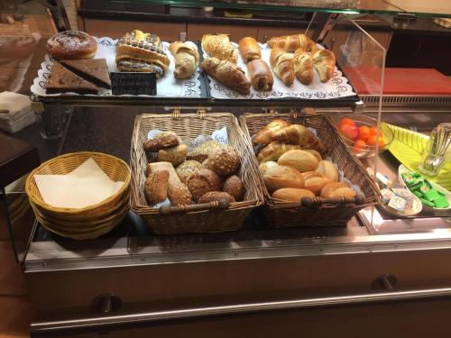 a display case with baskets of different types of pastries at Hotel Stadt Steinheim in Steinheim