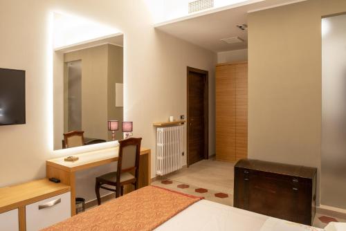 a bedroom with a bed and a desk and a desk at Portica10 Assisi in Assisi