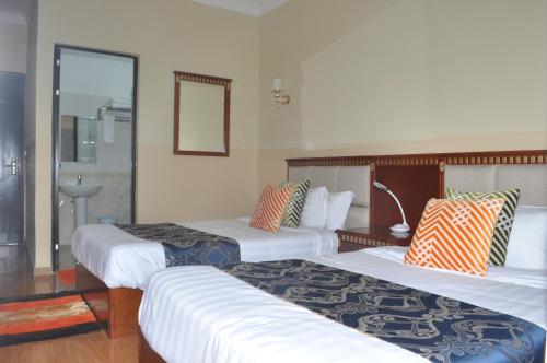 Ένα ή περισσότερα κρεβάτια σε δωμάτιο στο Hôtel Sky blue Mada