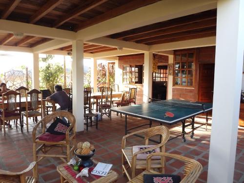 a patio with a ping pong table and chairs at The Sea Garden House in Olón