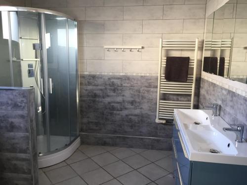 a bathroom with a shower and a sink and a tub at Villa Toscana 250 M de la plage in Agon-Coutainville