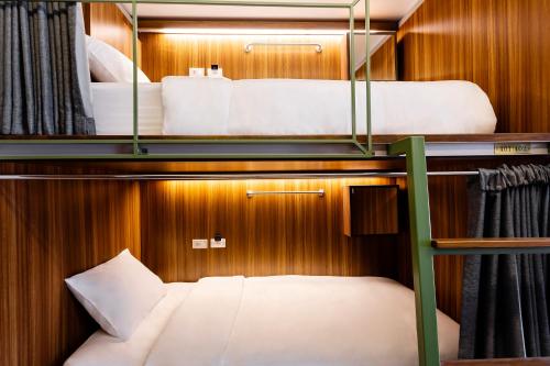 a room with two bunk beds on a boat at Khunluang Hostel in Chiang Mai