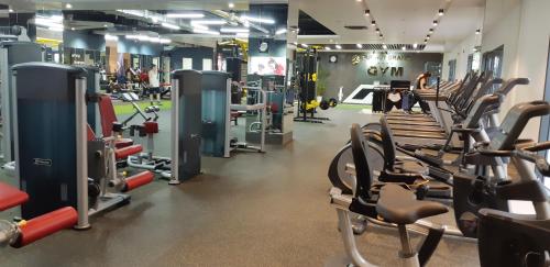 a gym with lots of cardio equipment and treadmills at Duc Huy Grand Hotel in Lao Cai