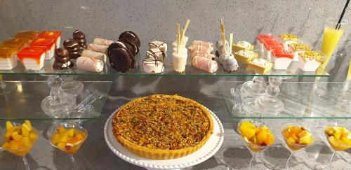 a display case with a pie and a bunch of desserts at Achuza Bamarom in Safed