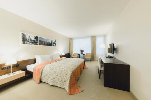 a hotel room with a bed and a desk at Residence Hotel in Vaduz