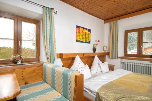 a bedroom with a bed and a window at Landhotel Binderhäusl Garni in Inzell