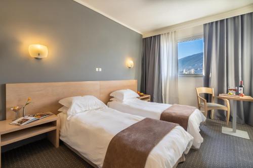 Postel nebo postele na pokoji v ubytování Nestos Hotel