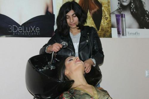 a woman getting her hair cut at a salon at Paradise Investment Resort in Tʼelavi