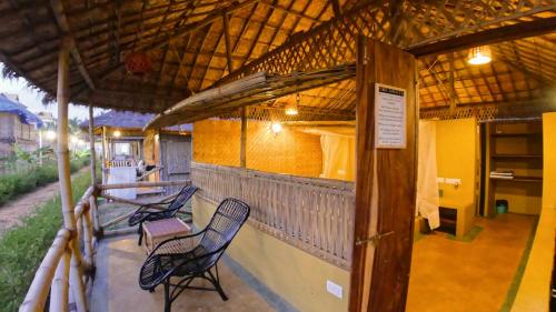 a group of chairs sitting on top of a building at Beach Street Eco Resort - Mandrem in Mandrem