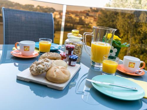 a table with a tray of donuts and glasses of orange juice at Holiday Dream in Vrsar