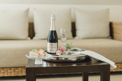 a bottle of wine and a glass on a table at Residence Hotel in Vaduz