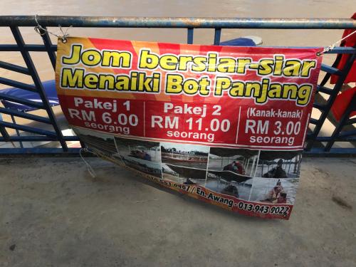 a sign hanging from a metal rail at PATIN GUEST HOUSE @DESA TELOK IRA, TEMERLOH PAHANG in Kampong Paya Kerinau