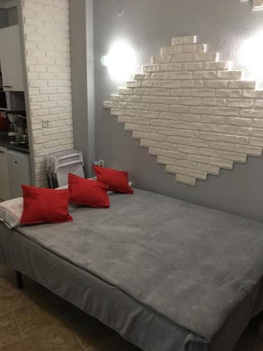 a bedroom with a large bed with red pillows at Denia Playa I in Denia