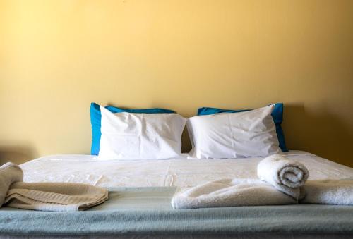 a bed with white sheets and towels on it at Lucky 2 in Paralimni