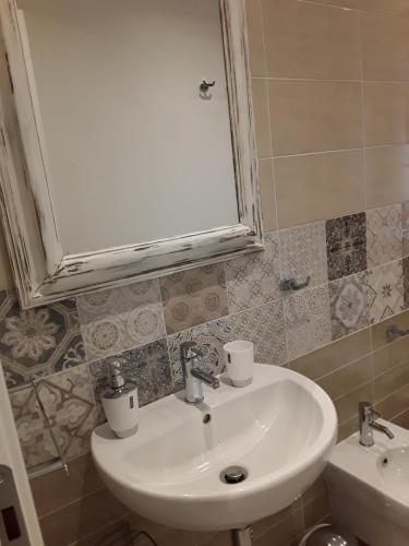 a bathroom with a sink and a mirror at Prima Fila in Lerici