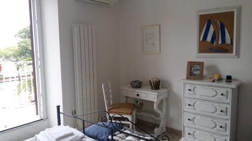 a bedroom with a bed and a dresser and a window at Prima Fila in Lerici