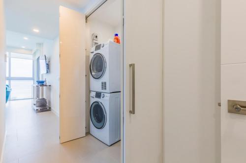 a laundry room with a washer and dryer at Azure Beach Residences in Palm-Eagle Beach
