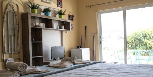 a bedroom with a bed and a tv and a window at Lucky 2 in Paralimni