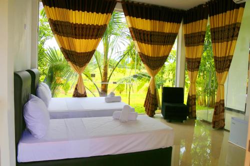 Ένα ή περισσότερα κρεβάτια σε δωμάτιο στο Rivonway Hotel Polonnaruwa