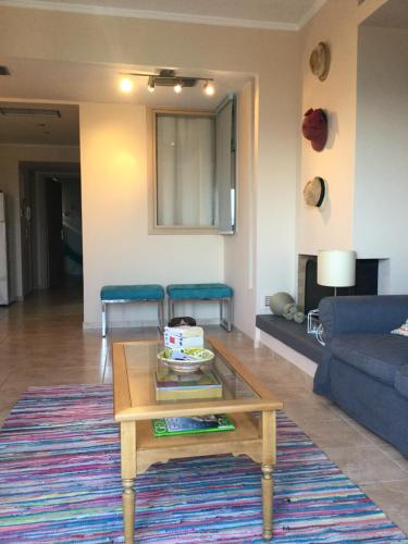 a living room with a coffee table and a couch at Seafront apartment ΙΙ in Kiveri, near Nafplion. in Kivérion