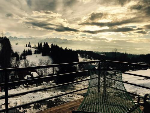 a view of a snow covered mountain with a cage at Rzepiska Hills in Rzepiska