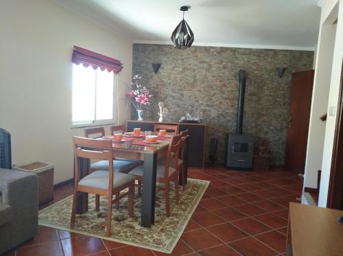 a dining room with a table and chairs at Casa D. Antónia in Gouvães