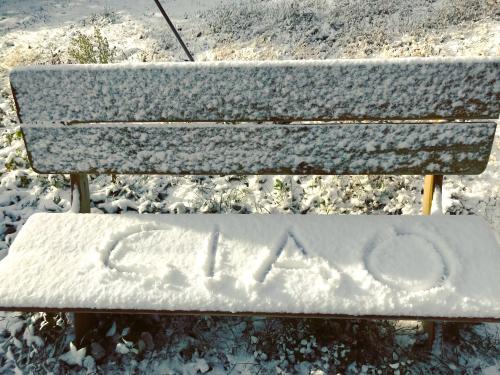 a bench covered in snow with the word ak written on it at Casa Martino in Villa