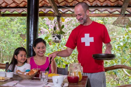 a man and a woman sitting at a table at Finca de la Vaca - Family House in Mera