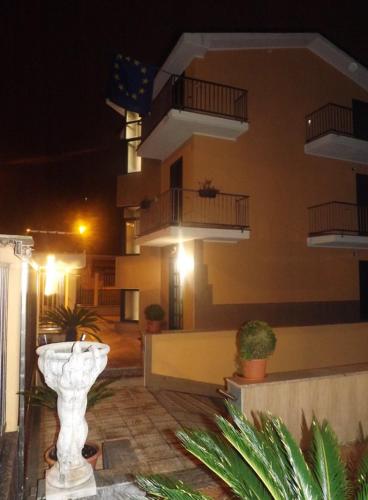 a building with a white vase in front of a building at Affittacamere Pone in Sesto San Giovanni