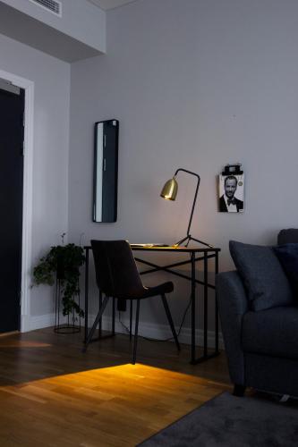 a living room with a desk and a couch at Livin Station Hotel in Örebro