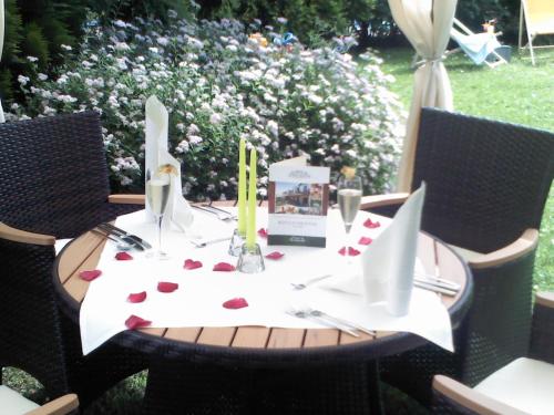 a table with red hearts on a white table cloth at Landhotel Dresden in Dresden