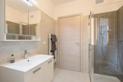 a bathroom with a sink and a shower at Baveno Hills | Lakeview apartments in Baveno