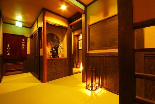 a hallway of a building with a lamp on the floor at Ichidaya in Toyooka