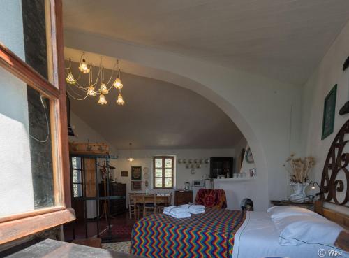 ヴェルナッツァにあるMuin a Ventu Historical Towerのアーチ道のある部屋で、ベッドルーム1室(ベッド1台付)
