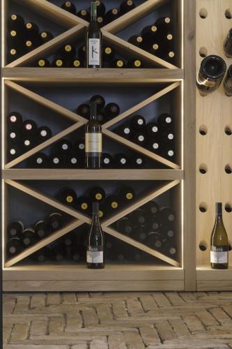 a wine cellar with bottles of wine at TiAMo Modern Design Guest House in Ronchi dei Legionari