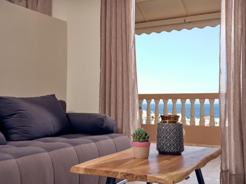 a living room with a couch and a table at THREE GRACES Apartments ZAKYNTHOS TOWN in Zakynthos Town