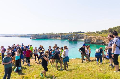 a group of people standing on a hill near the water at Trapetum-Salento domus in Cursi