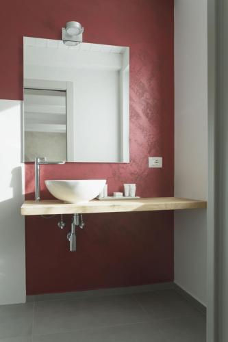 a bathroom with a sink and a mirror at TiAMo Modern Design Guest House in Ronchi dei Legionari