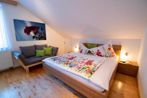 a bedroom with a large bed and a couch at Ferienwohnungen Lichtenegger in Kamp