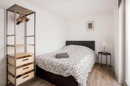 a bedroom with a bed and a book shelf at Charmant appartement au coeur du Vieux Lille in Lille